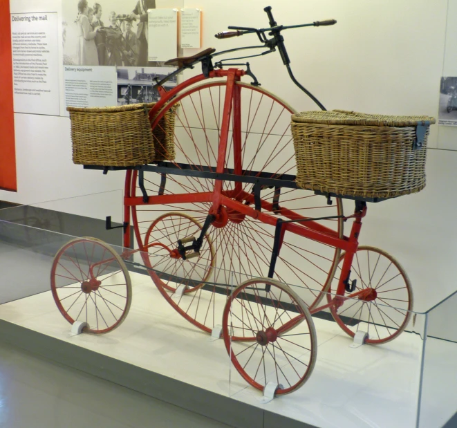 an old style bike sitting in a museum display