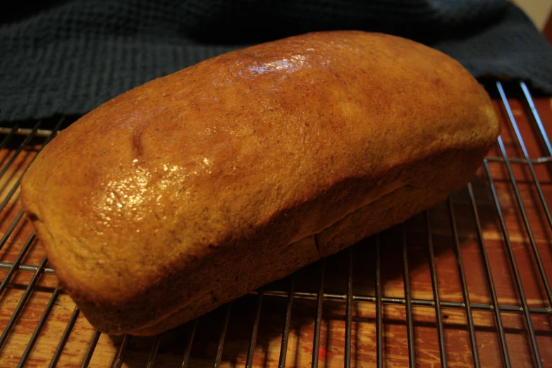 a loaf of bread on top of a cooling rack