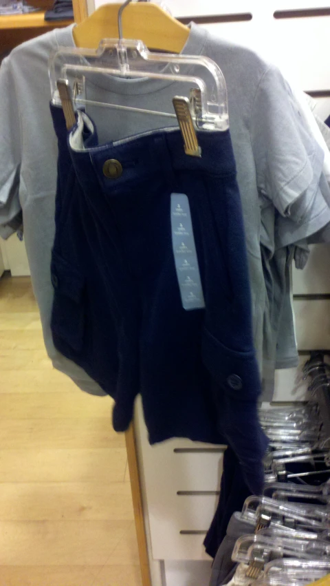 shirt with blue jeans hanging on a rack