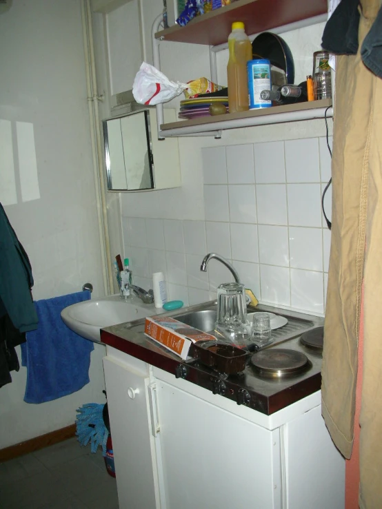 a kitchen with a sink, cabinets, and dishes