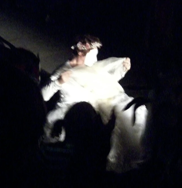 a young bride wearing a veil is laying down on the couch