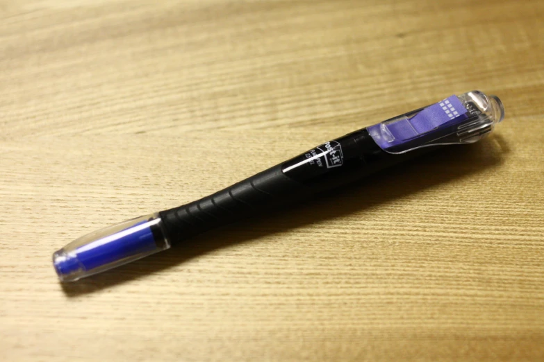 a pen with black ink on it is on a table