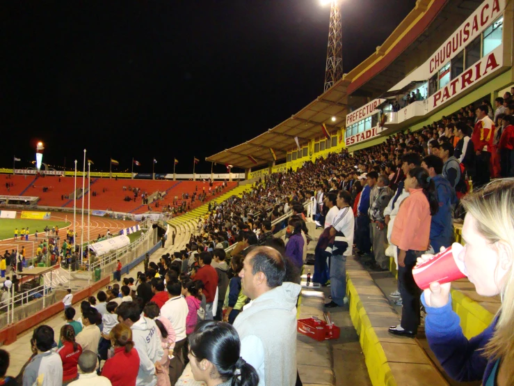 an audience watches as the lights go out at night