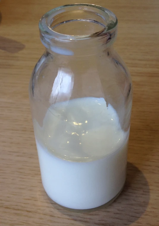 the jar is full of milk on the table