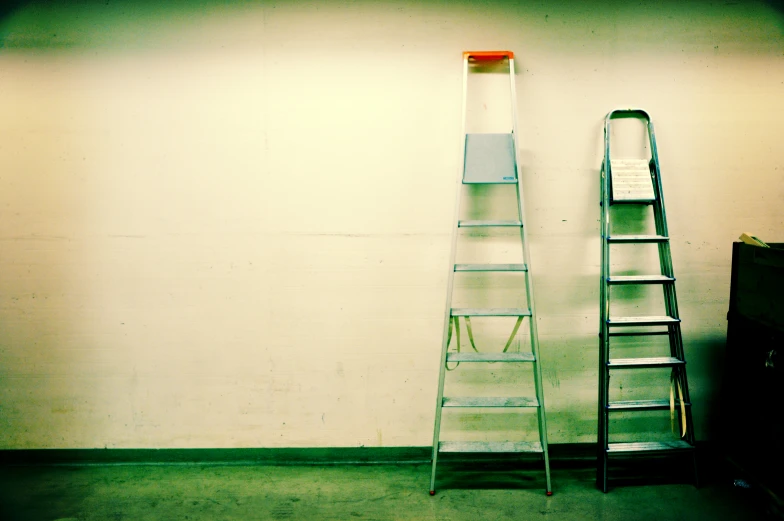 a leaning ladder is next to a small tv on a table