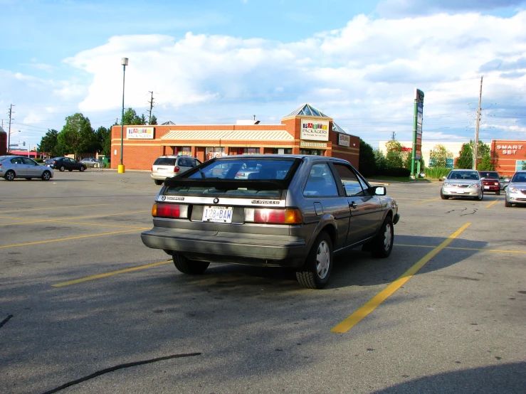 a car sits in a parking lot where people are parked