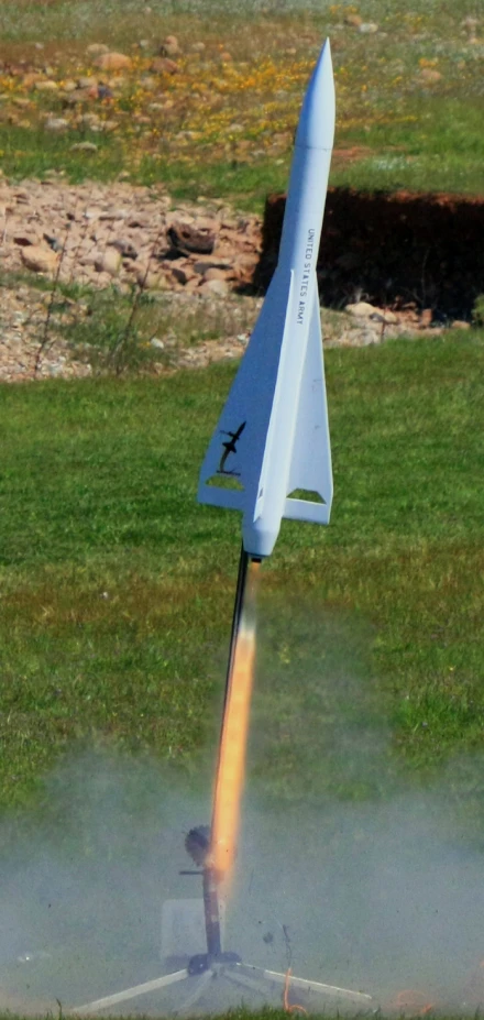 a rocket flying through the air and hitting a rock