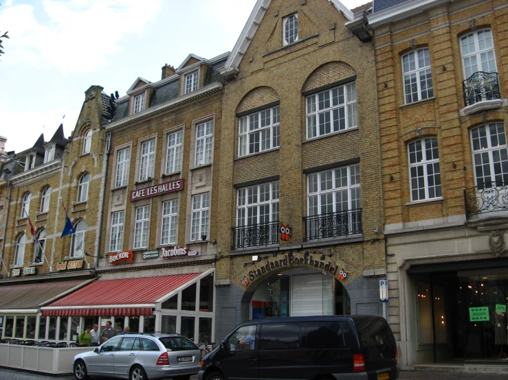 some cars parked in front of an old building