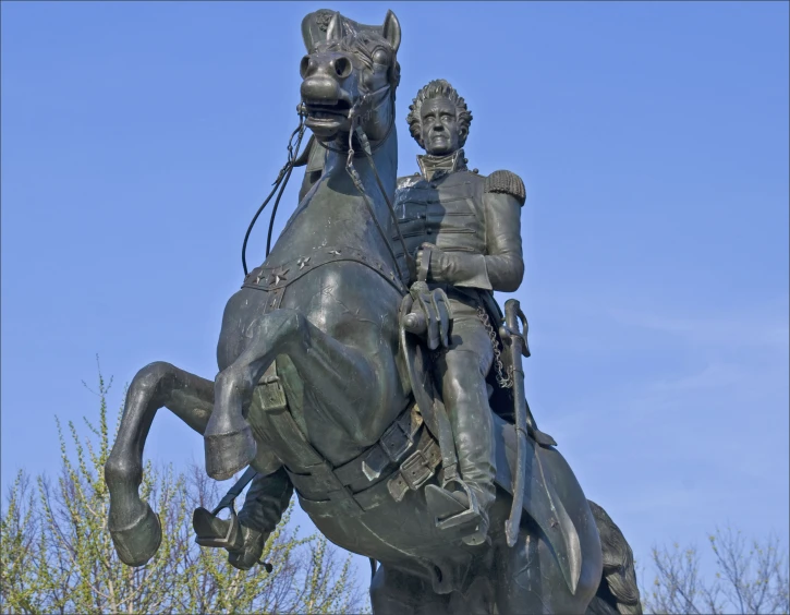 a statue of a man riding on top of a horse