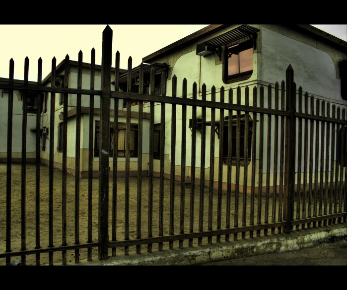 a large building with a gated in area next to it