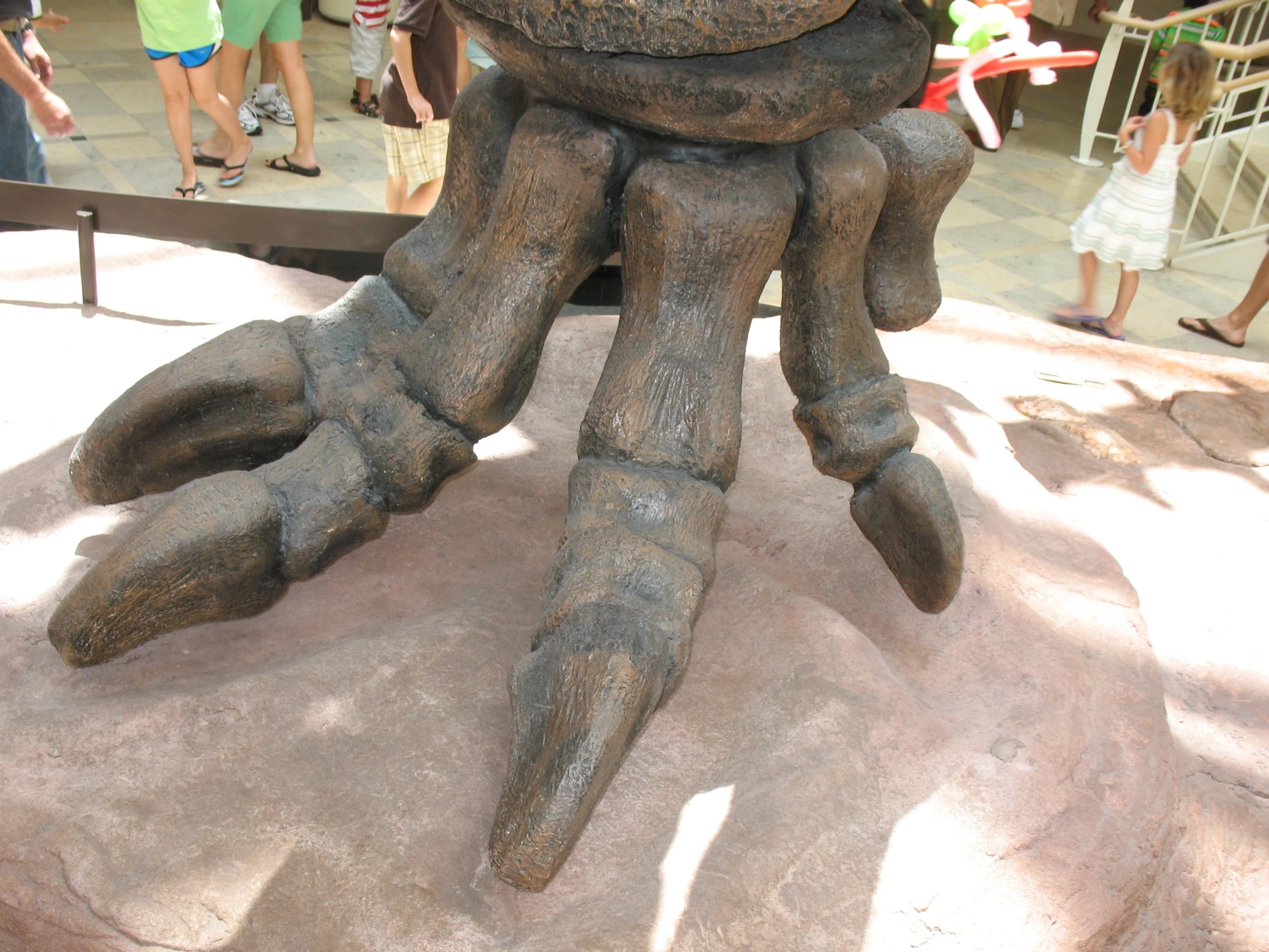 a statue with the feet and arms of a human