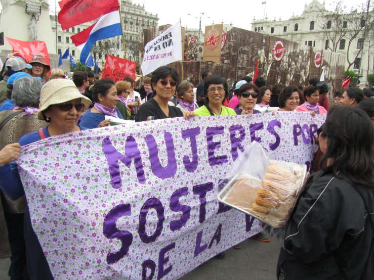 many people are holding a sign in a parade