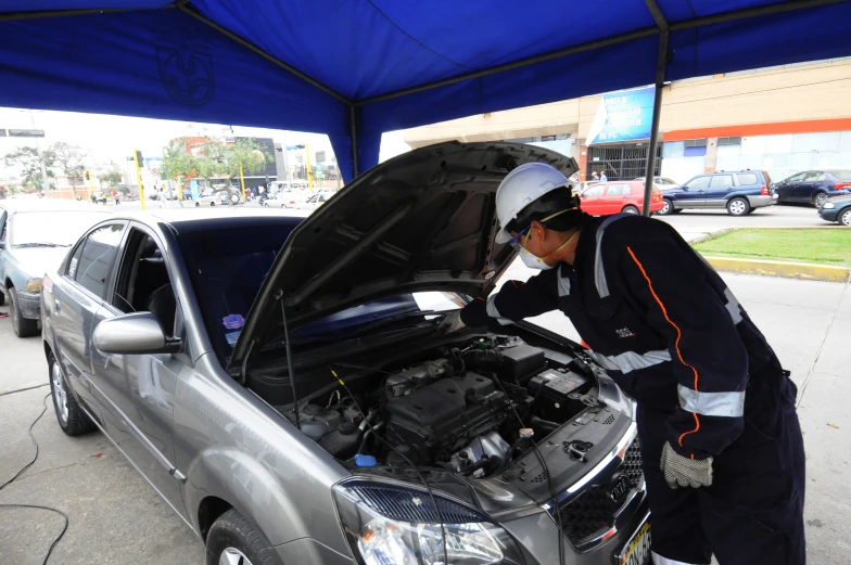 a man is working on his car's engine