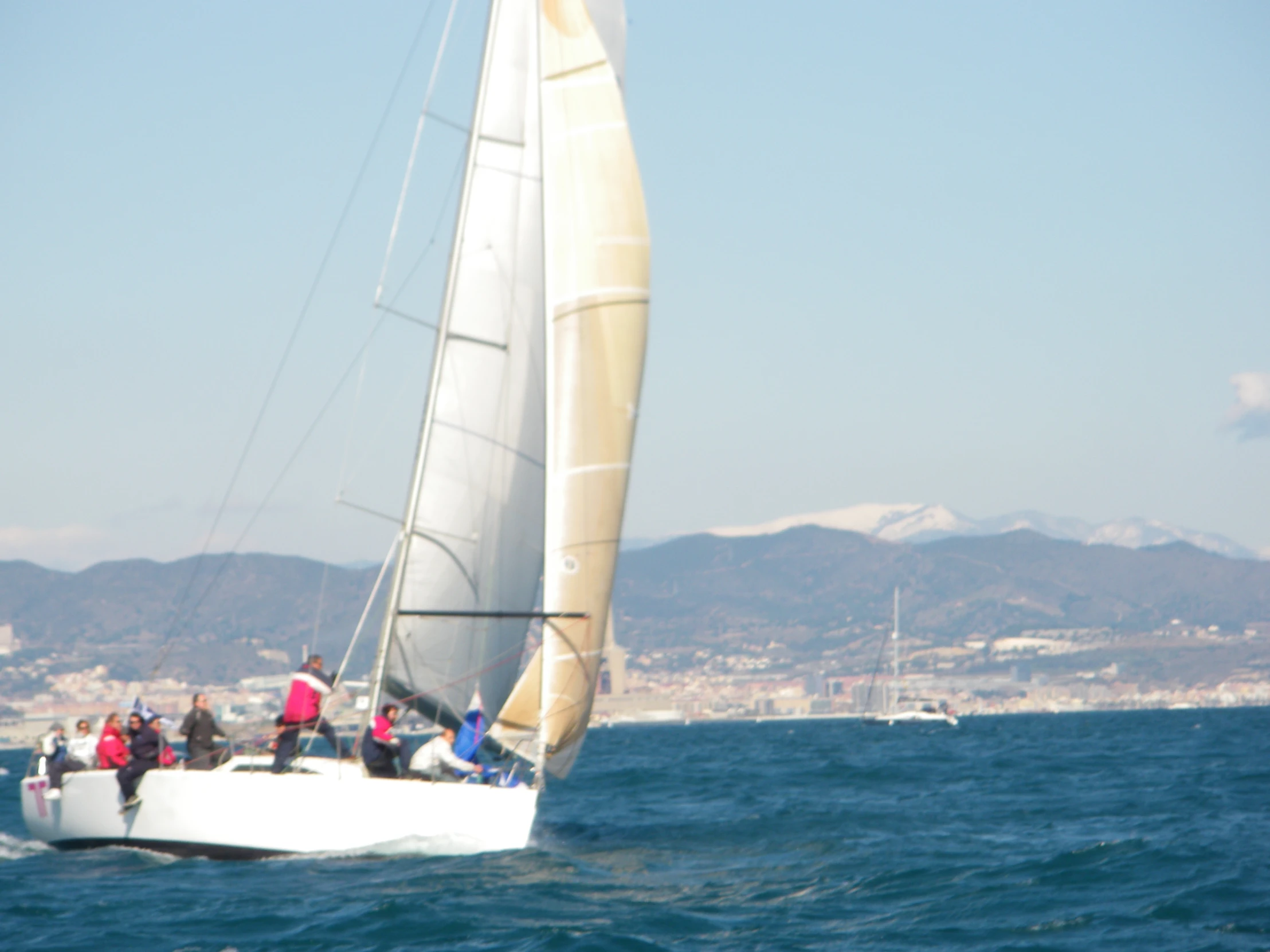 people on a sailboat sailing in the ocean