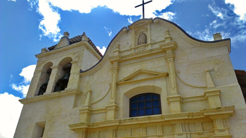 an old building with a small cross at the top