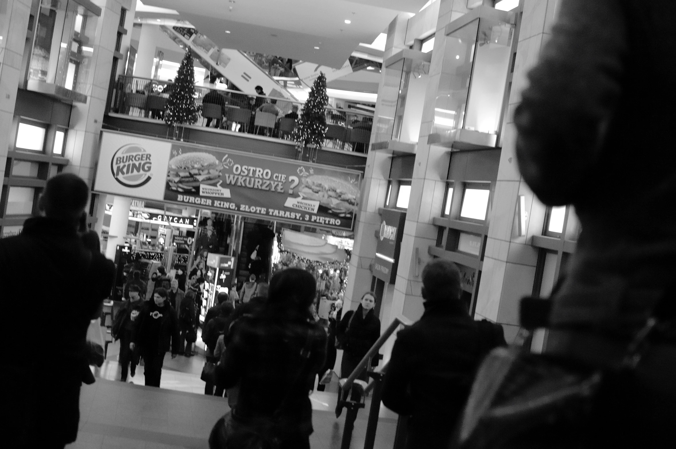 people walking up and down the stairs at a mall