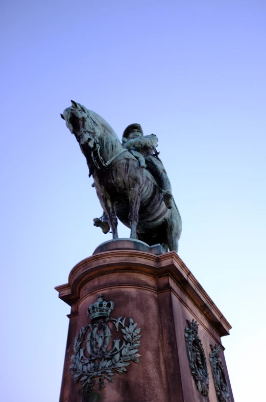 a statue on top of a brown tower