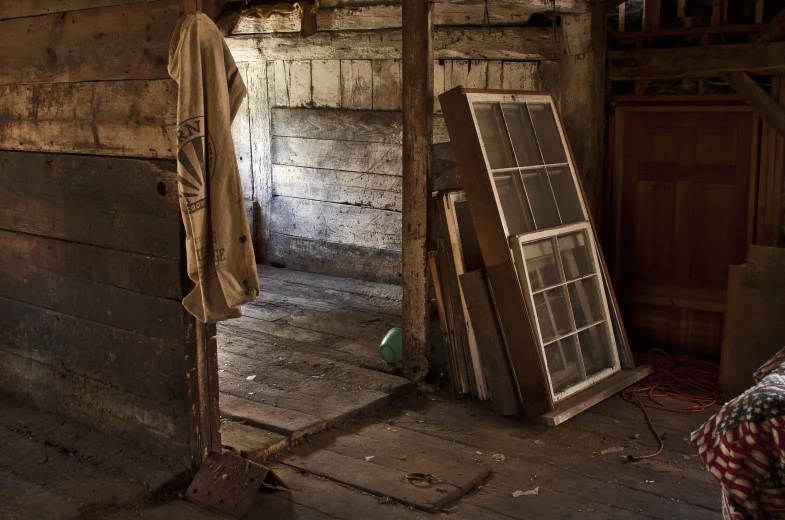 an old house with a wooden door, window and a clothes stand