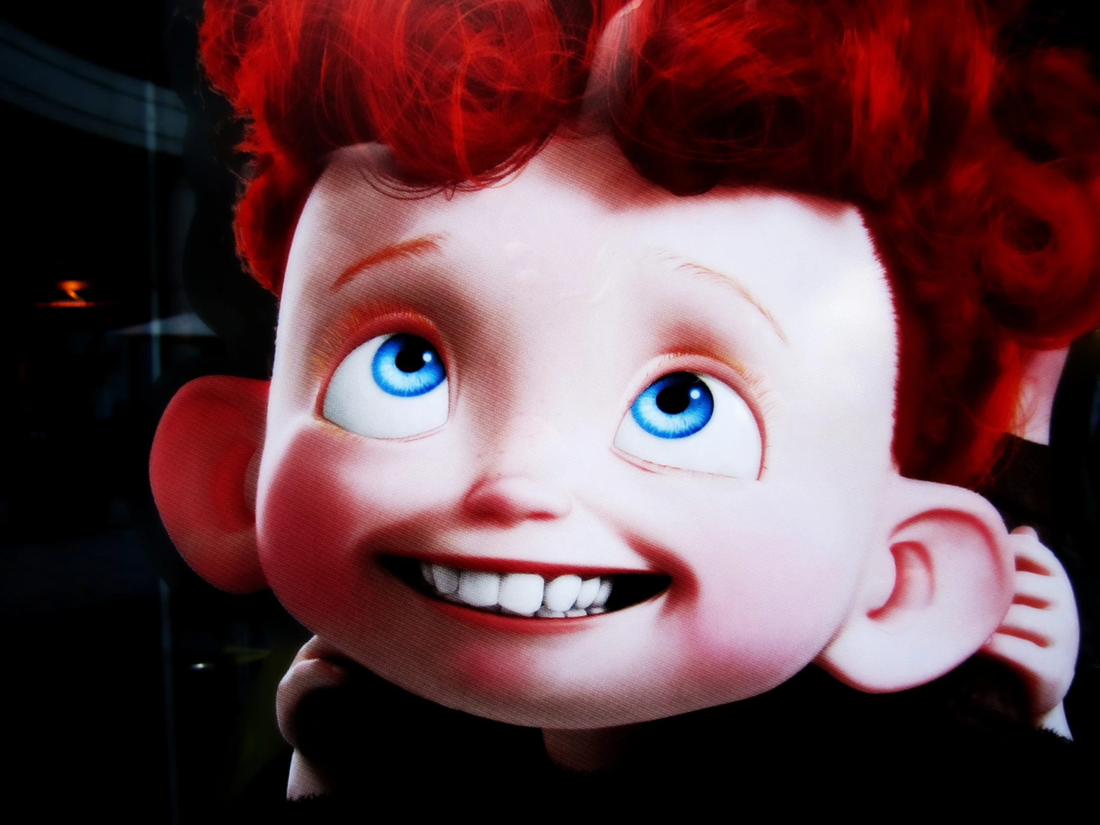 a little boy with red hair and blue eyes smiling