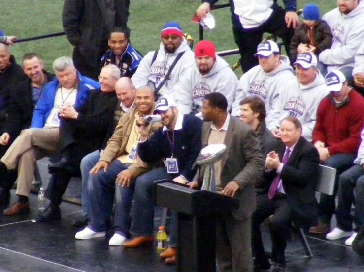 people sitting on seats at the baseball game