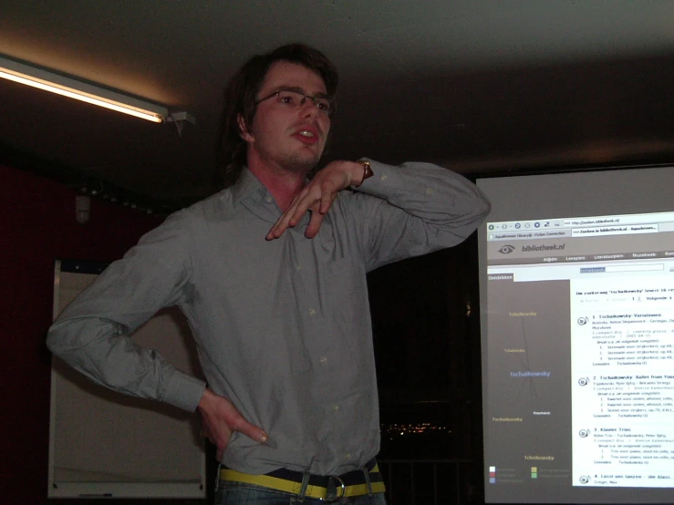 a young man is using his hand gestures to speak