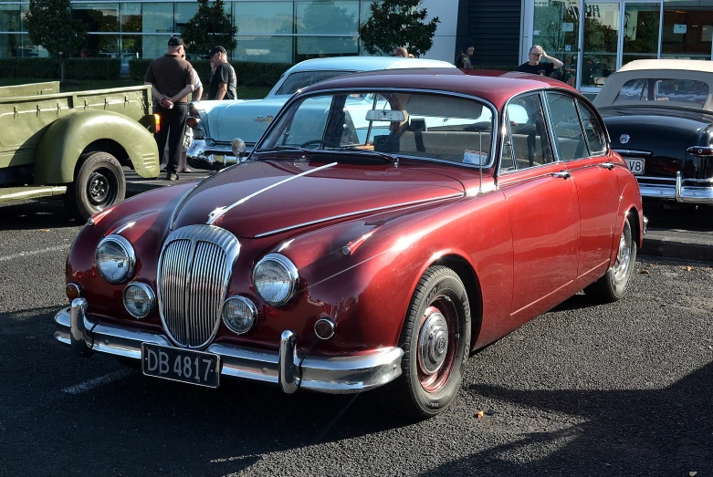 classic cars in the parking lot with others parked