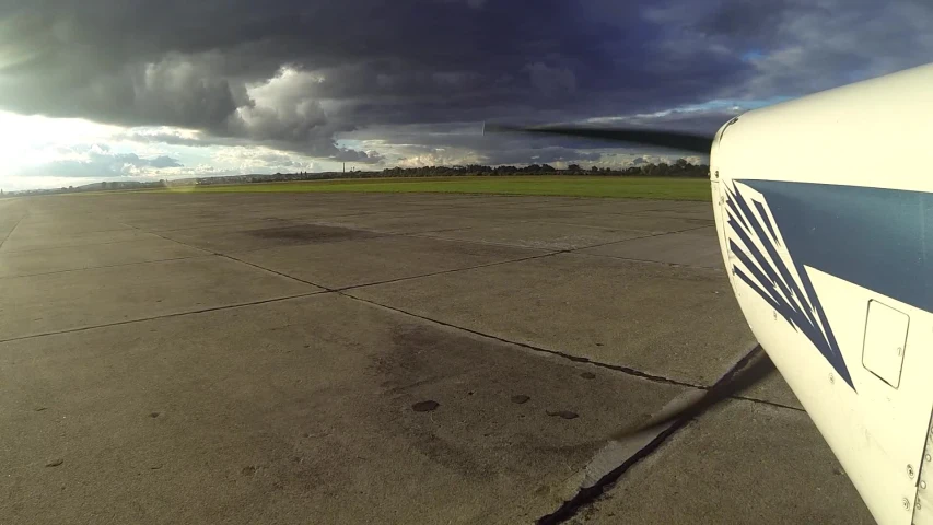 an airplane with the sun shining through clouds above it