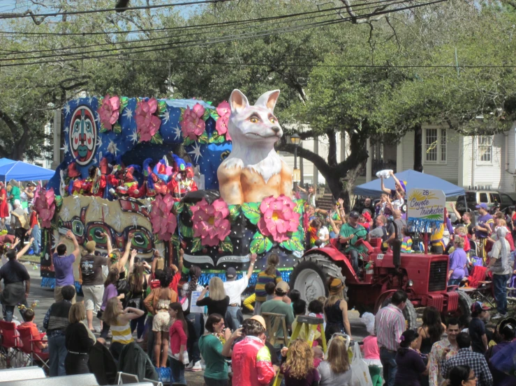 people standing around in front of an animal float