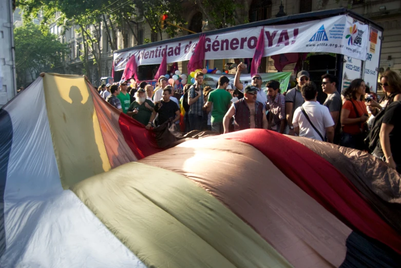 a crowd is gathered around tents that are all different colors