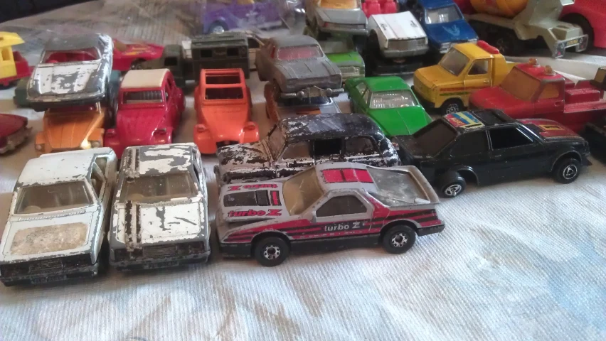 a bed is packed full of toy cars
