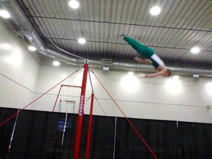 an athlete in mid air on a pole