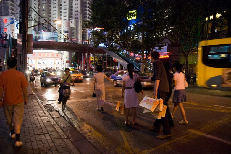 some people are walking along a city street