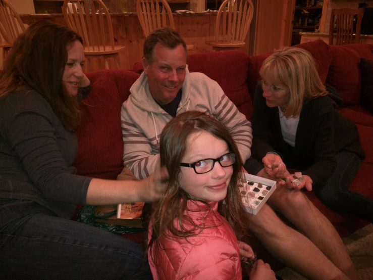 a group of people are sitting on the couch together