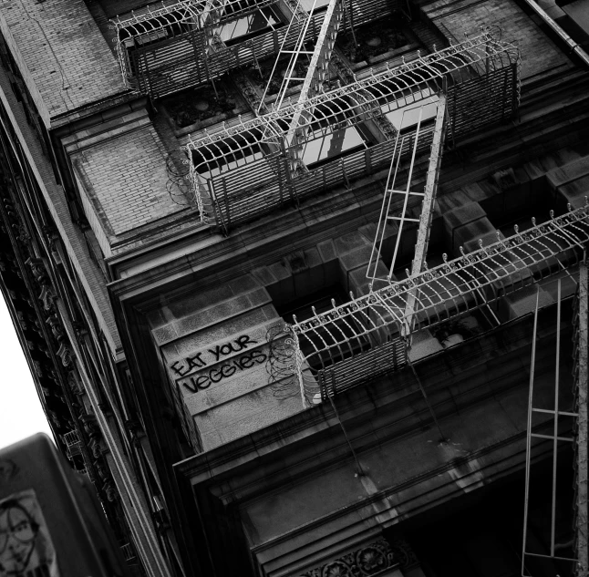 fire escapes on an old building with a sky scr