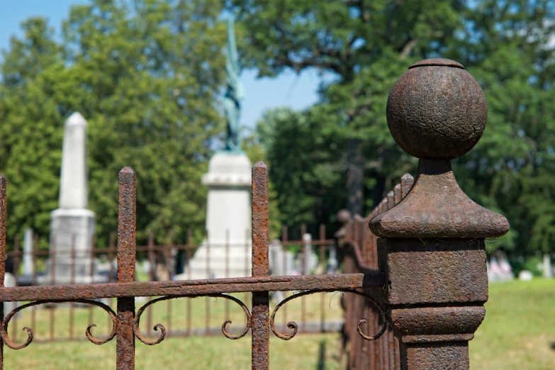 a metal fence in front of a cemetery