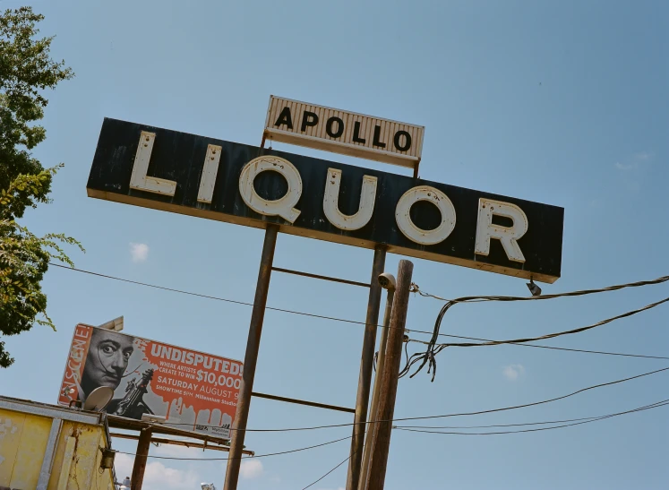 the back sign for liquor on a street corner