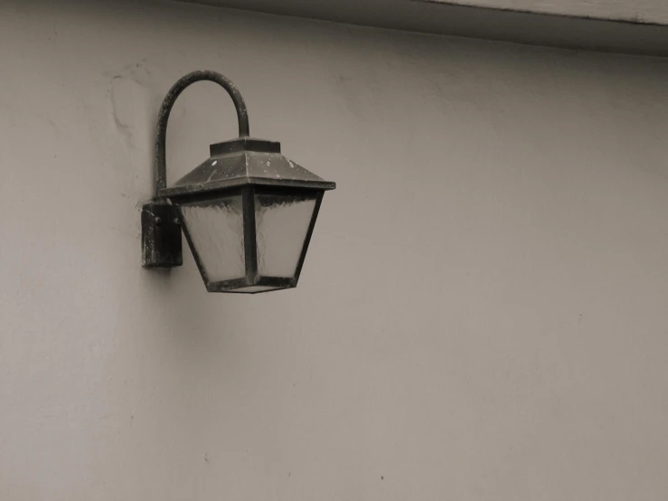 a wall mounted light hanging on a side wall