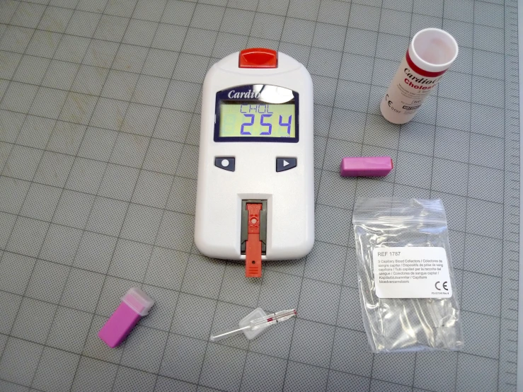 a small  test device sits next to a tube of medicine