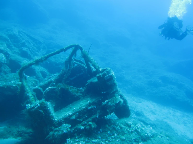 an underwater view shows the back end of a boat