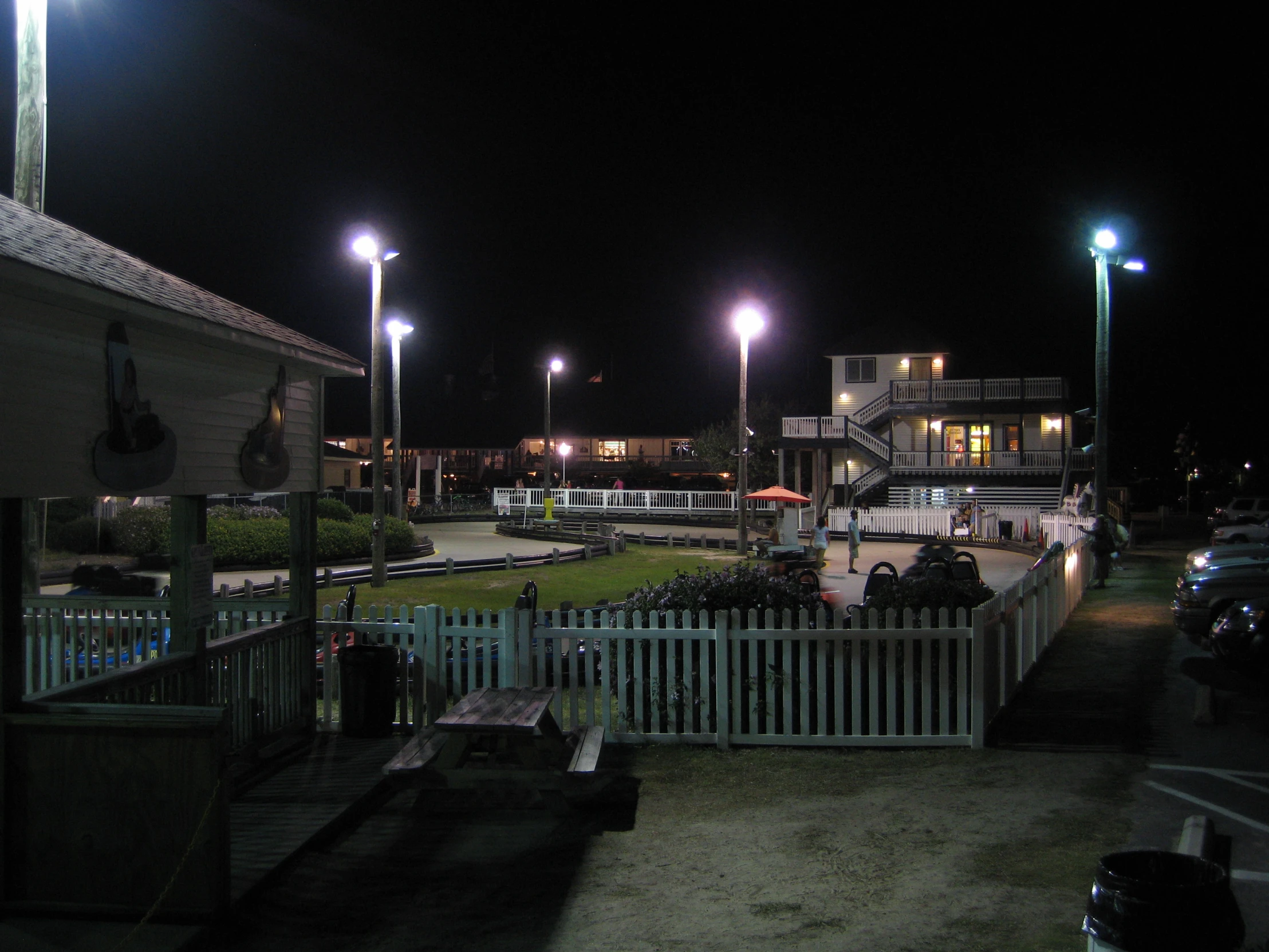 several lights that are on in the dark over buildings