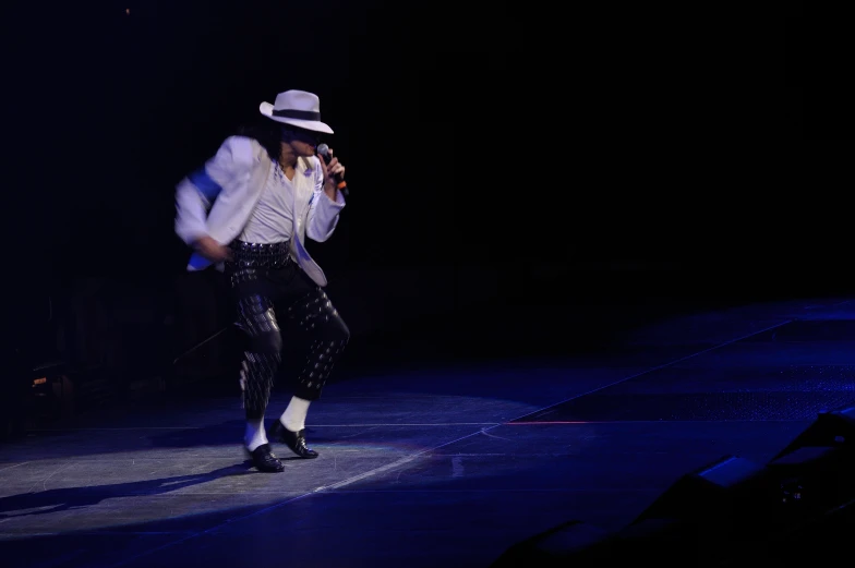 a man in white top hat on stage