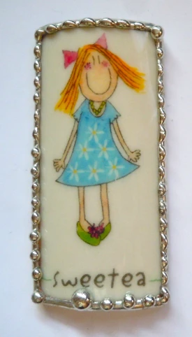 a pendant with a drawing of a little girl