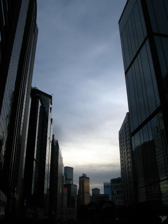 buildings in a city at twilight on a cloudy day