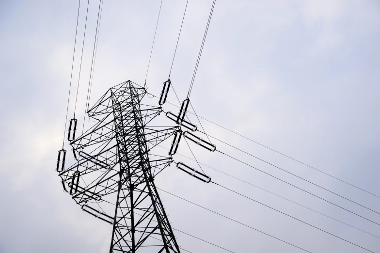 an electrical tower with many wires and a clock tower