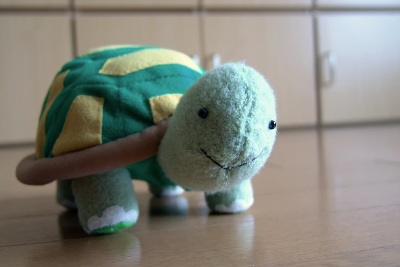 a stuffed turtle with a wooden stick