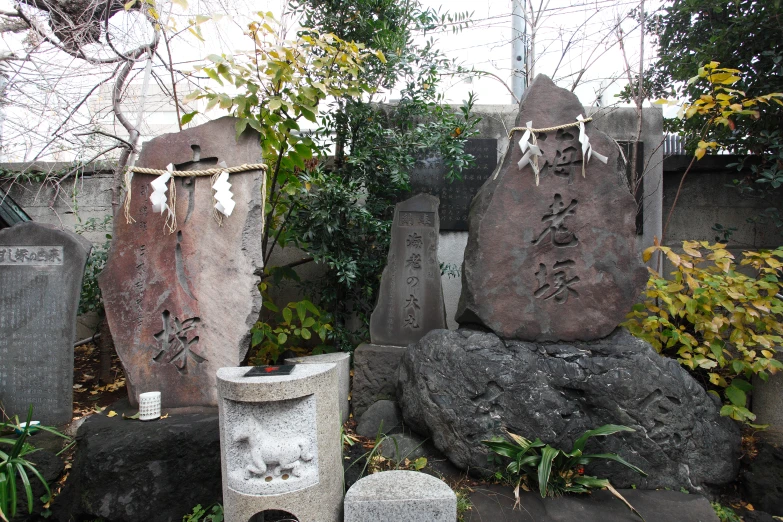 a set of rock sculptures is decorated with japanese writing