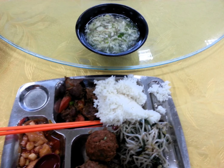 a couple of trays filled with food on top of a table