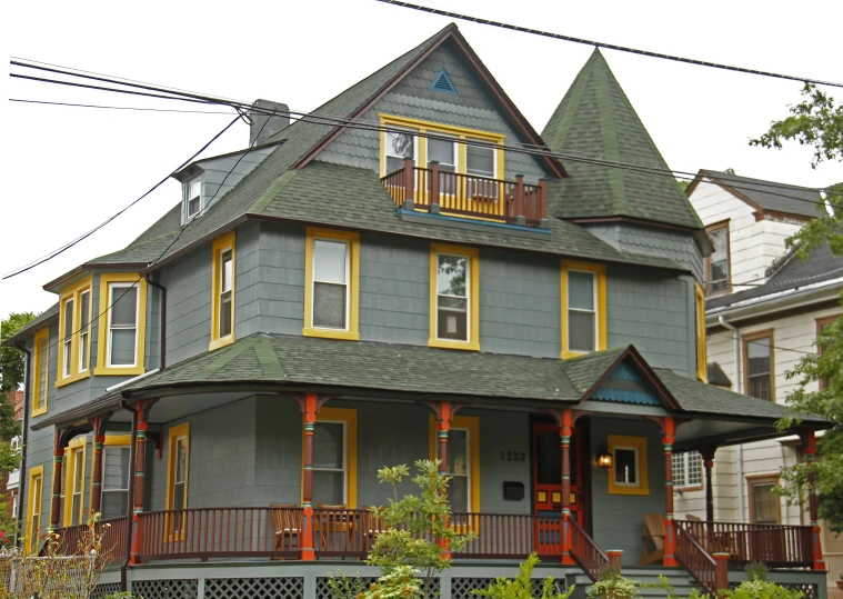 a gray and yellow house in a small neighborhood