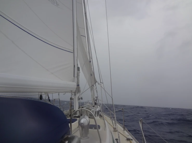 a sailboat on the water with large waves