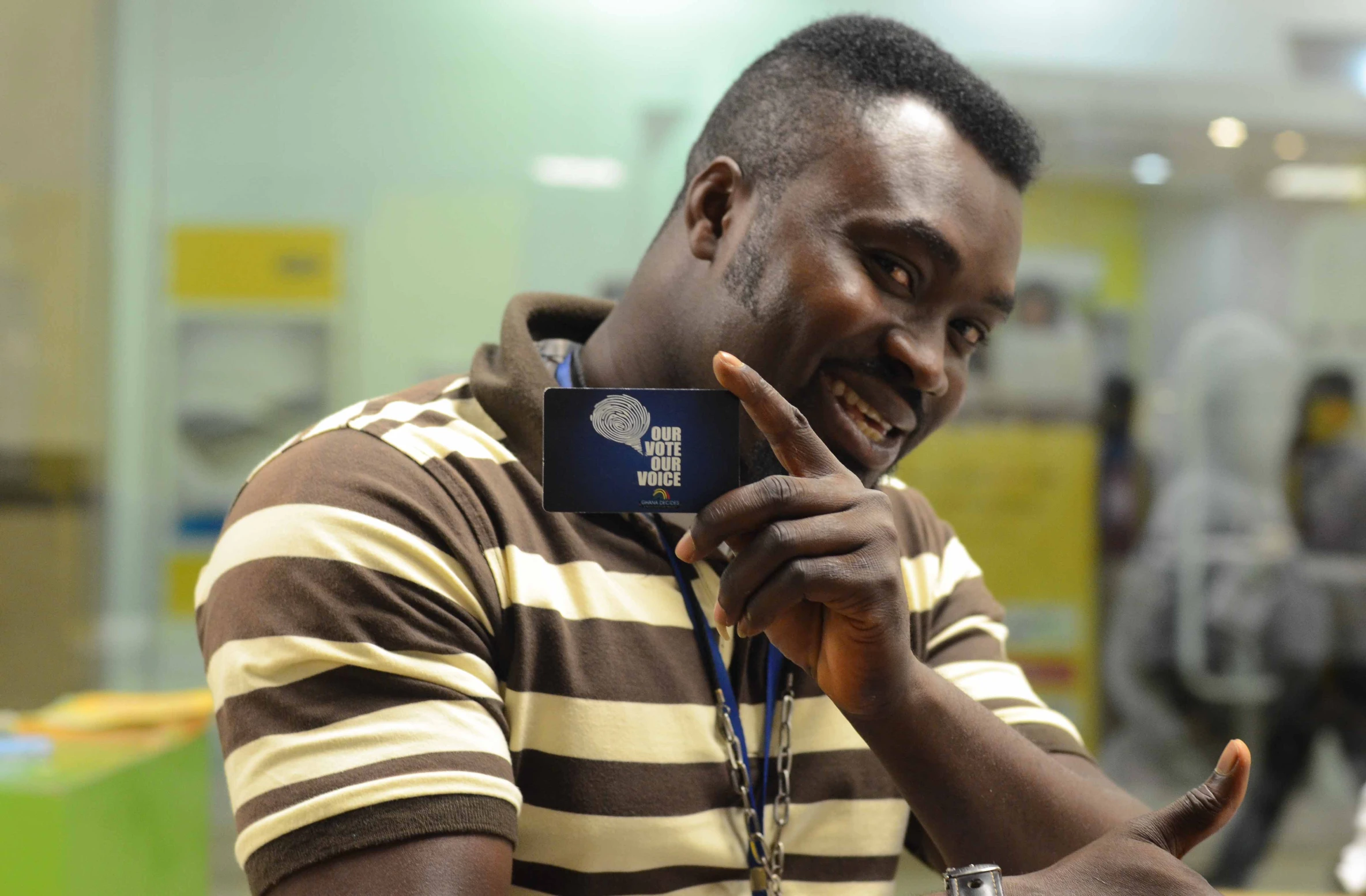 a young man is holding a credit card with the finger